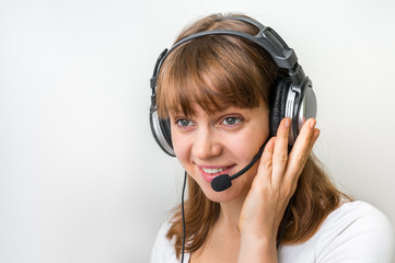 Call centre operator with headset at workplace in call center