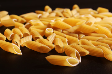 Italian pasta, still life on black background