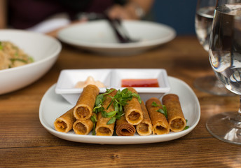 Lumpia Spring Rolls on Wooden Table in Restaurant