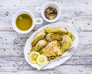 Baked fennel with herbs and olive oil served with fried fish. 
