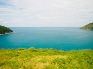 Blue sea green grass and island at Phromthep Cape phuket Thailand