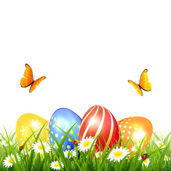 Butterflies flying over Easter eggs on grass