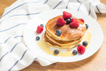 Breakfast. Berries. Pancakes. Romantic breakfast on a wooden table. Spring morning. Cozy.