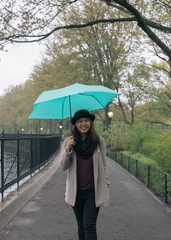 Asian Woman Holding Umbrella While Raining
