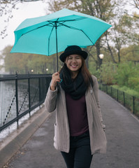 Asian Woman Holding Umbrella While Raining