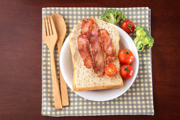 breakfast with bread and bacon in white dish