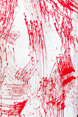 Blood splatter, red acrylic paint splash isolated on wall background texture