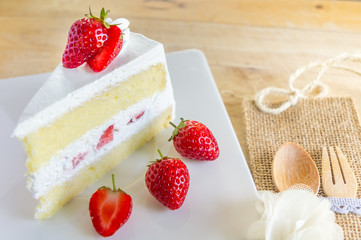 Closeup of strawberry cake with fresh strawberry on wooden background. Homemade strawberry cake.