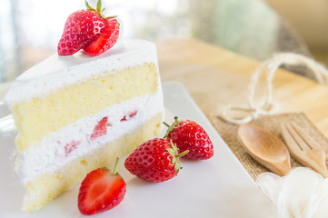 Closeup of strawberry cake with fresh strawberry on wooden background. Homemade strawberry cake.