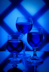 Toned photo. View from above. Wine in a glass. Blue. Design.
