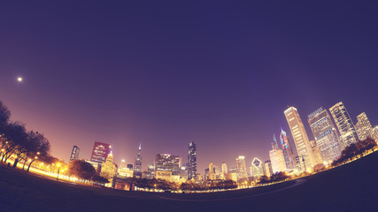 Fisheye lens distorted color toned picture of Chicago skyline at night, USA.