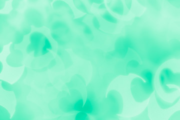 Fototapeta na wymiar Valentine's day abstract background of soft green mint bokeh blur hearts. Festive valentine backdrop.
