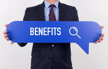 Businessman holding speech bubble with a word BENEFITS