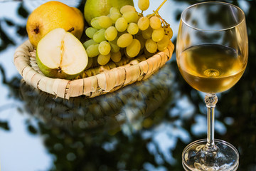 ripe appetizing grape, pears and glass of wine