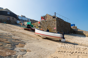 Fototapeta na wymiar Small fishing boats in the harbour at Sennen Cove Cornwall England UK Europe