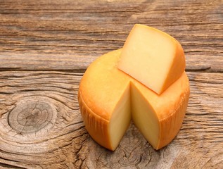 Cheese wheel on wooden table