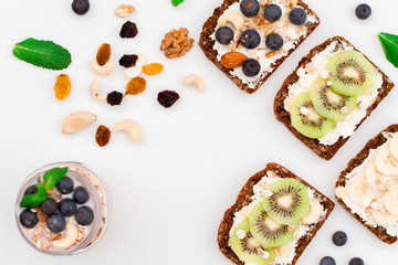 Muesli, nuts and berries. Breakfast preparation. Granola with fresh berries in jar on stone background, top view, banner. Healthy food and Clean Eating concept