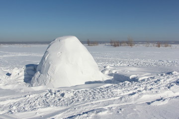 Igloo  standing on a snowy glade  in the winter