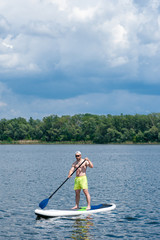 Fototapeta na wymiar man practicing paddle board 04