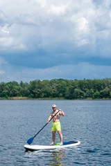 Foto op Canvas man practicing paddle board 04 © serguastock