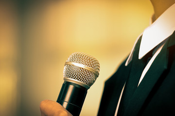 blurred of smart businessman speech, talking with microphone, gray scale tone