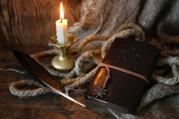 retro book candle and feather