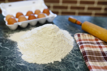 different ingredients for preparing flour products on kitchen table