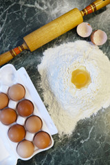 different ingredients for preparing flour products on kitchen table