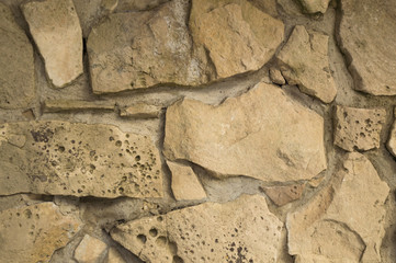 Old random limestone stone wall with mortar background