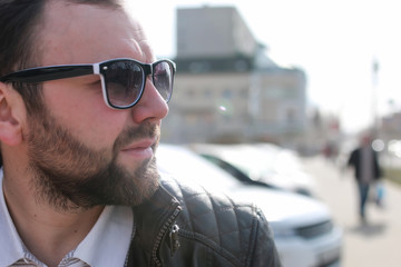 beard man in jacket and sunglasses street