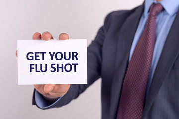 Man showing paper with GET YOUR FLU SHOT text