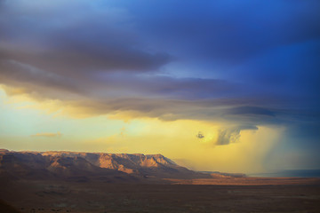 The storm over mountain Masada in Israel. The dramatic landscape, dark blue sky above the mountain. 