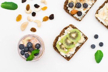 Breakfast. Muesli, nuts and berries. preparation. Granola with fresh berries in jar on stone background. Healthy food and Clean Eating concept