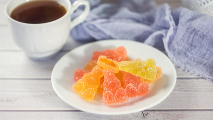 Colorful Jelly Candies Hares on white wooden table