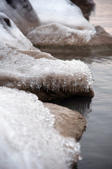 Obraz na płótnie Canvas closeup of ice covered rocks along shoreline of Lake Michigan in winter