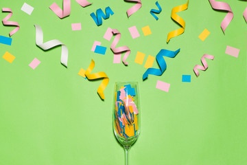 Celebration Flat lay with colorful party items on green background.