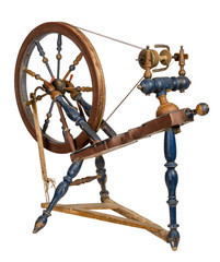 Old wooden spinning wheel isolated on white