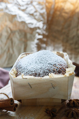  cake with powdered sugar on a brown background. Food shot with retro toning.