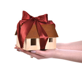 Image of woman hands holding wooden house