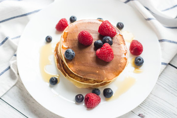 Breakfast. Berries. Pancakes. Romantic breakfast on a wooden table. Spring morning. Cozy.