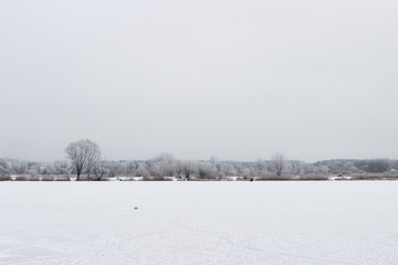 Fototapeta na wymiar White winter landscape frozen lake in the forest
