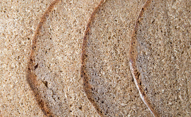 Home baked rye bread slices background