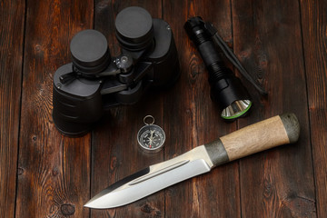 Kit of explorer or hunter on a wooden background