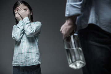 Very young girl spying on her drunk father