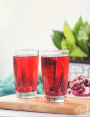Pomegranate juice in a glass and ripe pomegranate