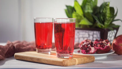 Pomegranate juice in a glass and ripe pomegranate