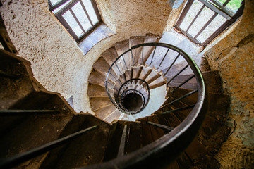 Spiral staircase in an abandoned castle