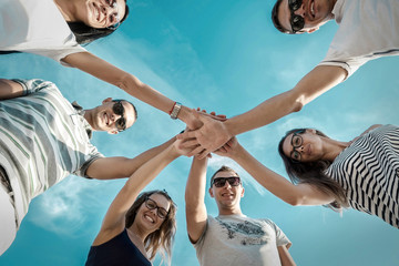 Group of friends on the beach under sunlight. - Powered by Adobe