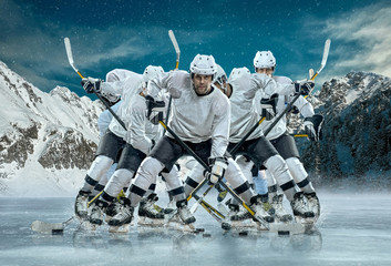 Ice hockey player in action outdoor around mountains