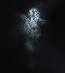 Dancer from smoke on the dark background